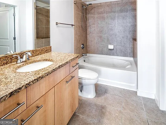 3324 Peachtree Road Northeast, Unit 2713 Atlanta, GA 30326 - Photo 12 of 29 a bathroom with a granite countertop bathtub shower sink mirror vanity and toilet