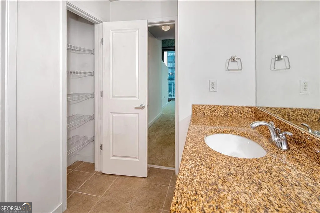 3324 Peachtree Road Northeast, Unit 2713 Atlanta, GA 30326 - Photo 13 of 29 a bathroom with a sink and a mirror