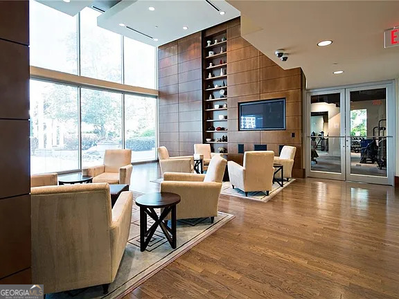 3324 Peachtree Road Northeast, Unit 2713 Atlanta, GA 30326 - Photo 16 of 29 a living room with fireplace furniture and a large window