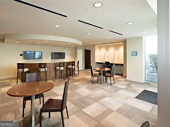 3324 Peachtree Road Northeast, Unit 2713 Atlanta, GA 30326 - Photo 17 of 29 a dining room with furniture and wooden floor