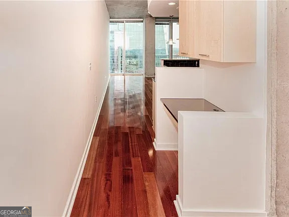 3324 Peachtree Road Northeast, Unit 2713 Atlanta, GA 30326 - Photo 7 of 29 a hallway with front door wooden floor and windows
