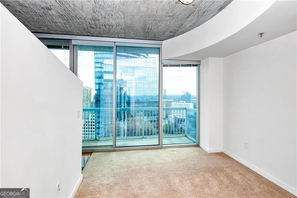 3324 Peachtree Road Northeast, Unit 2713 Atlanta, GA 30326 - Photo 10 of 29 a view of a room with wooden floor and sliding door