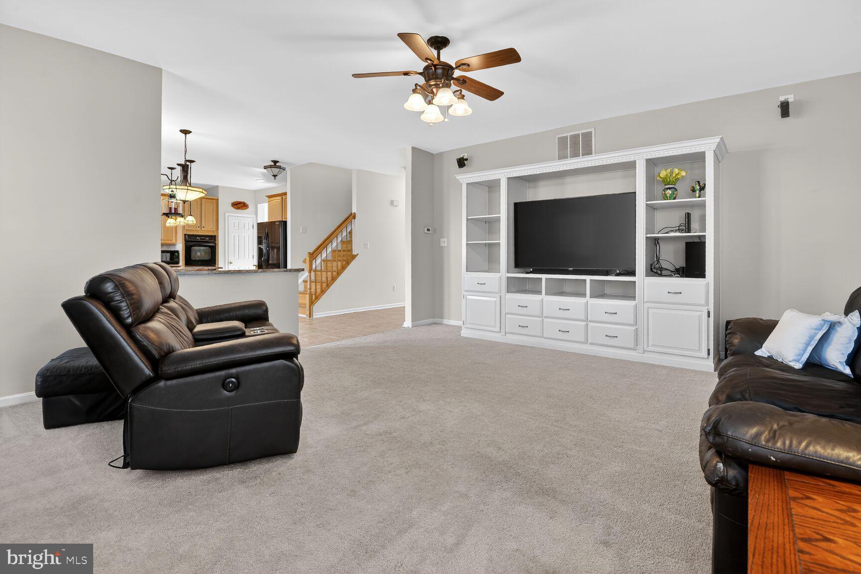 14272 Town Commons Way Gainesville, VA 20155 - Photo 11 of 32 a living room with furniture and a flat screen tv