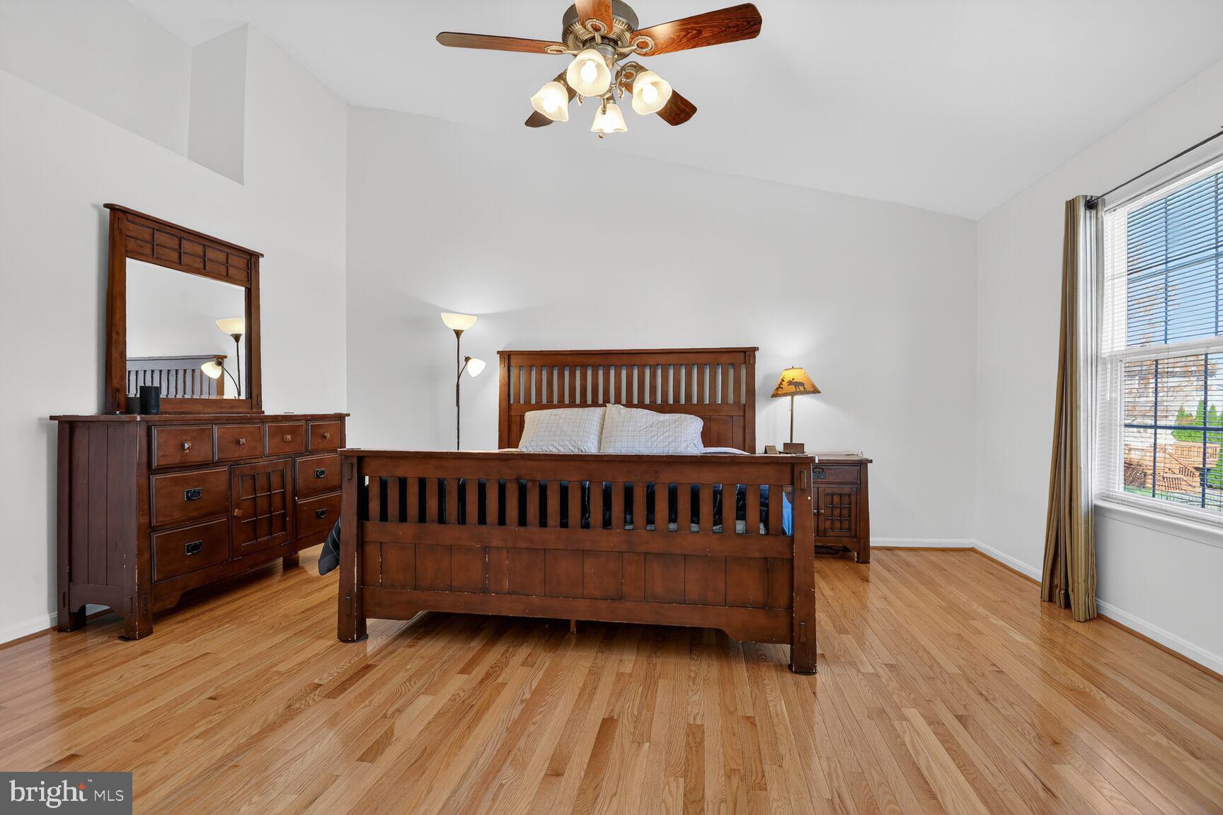 14272 Town Commons Way Gainesville, VA 20155 - Photo 16 of 32 a bedroom with a bed and wooden floor