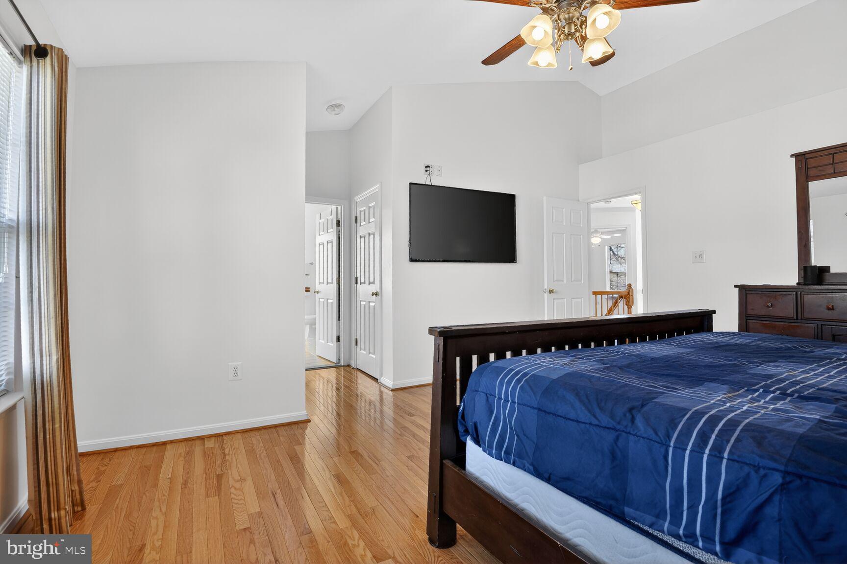 14272 Town Commons Way Gainesville, VA 20155 - Photo 17 of 32 a bedroom with a large bed and a flat screen tv