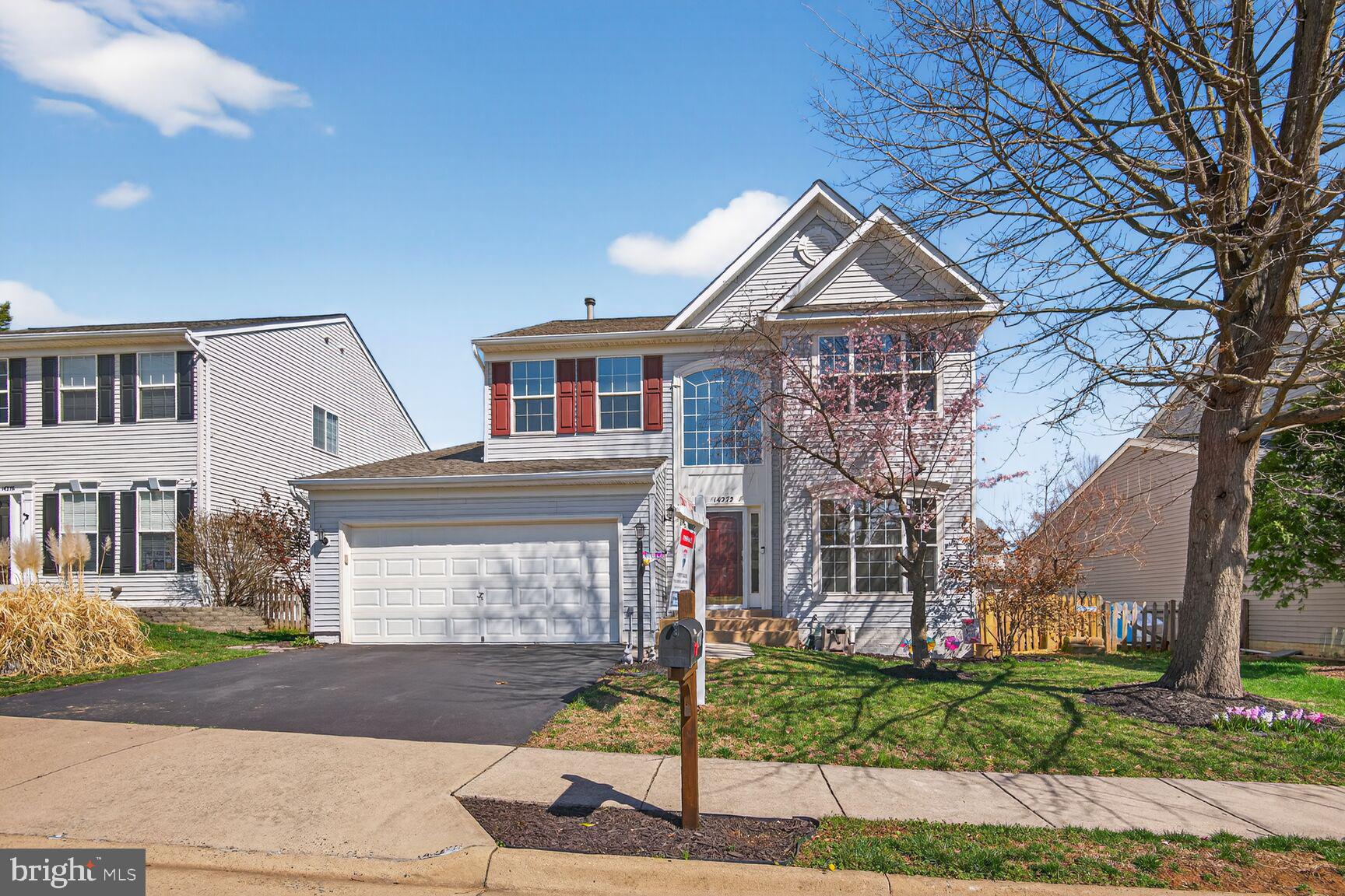 14272 Town Commons Way Gainesville, VA 20155 - Photo 2 of 32 a front view of a house with a garden