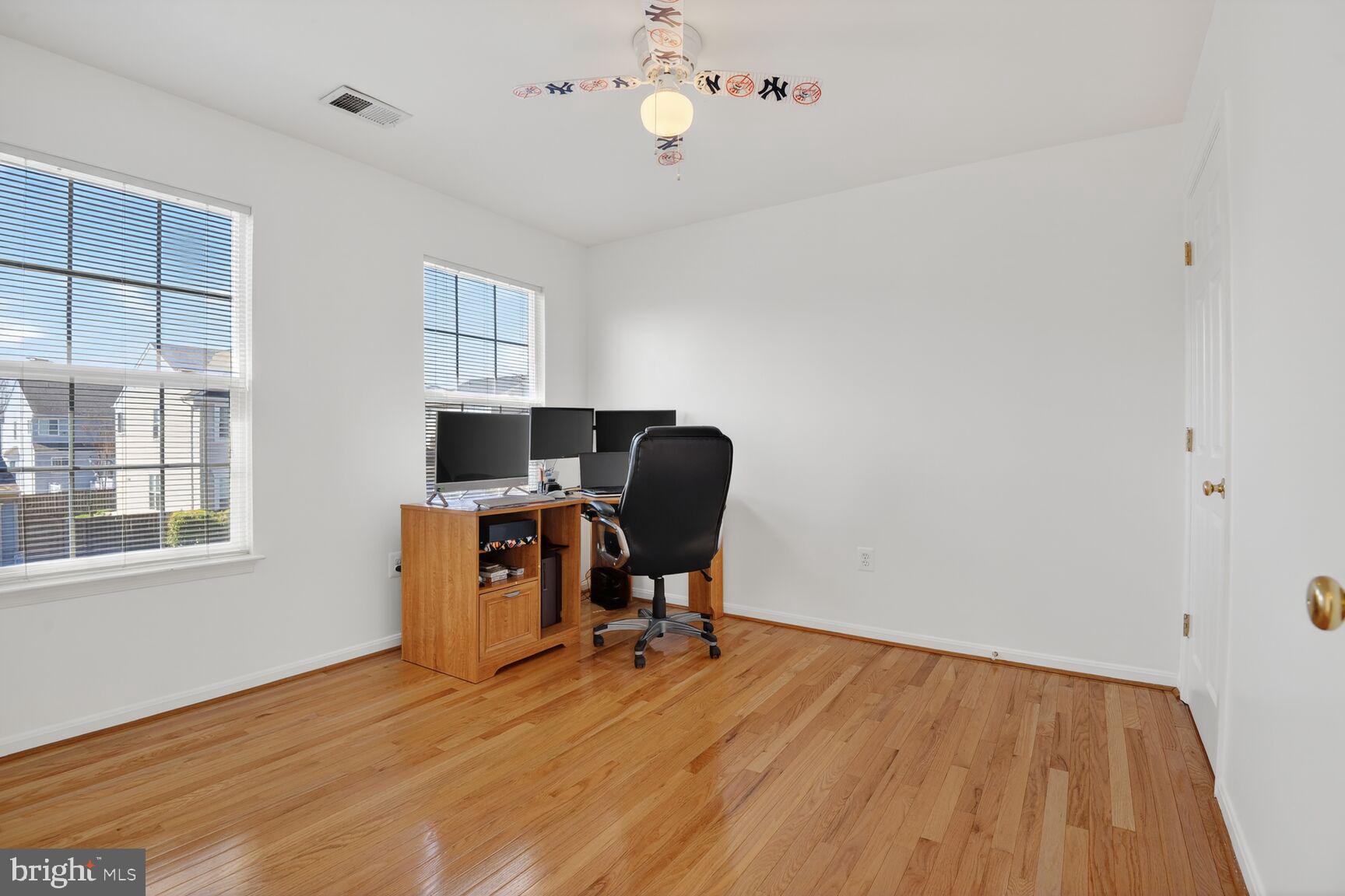 14272 Town Commons Way Gainesville, VA 20155 - Photo 20 of 32 a view of workspace with wooden floor windows cabinet