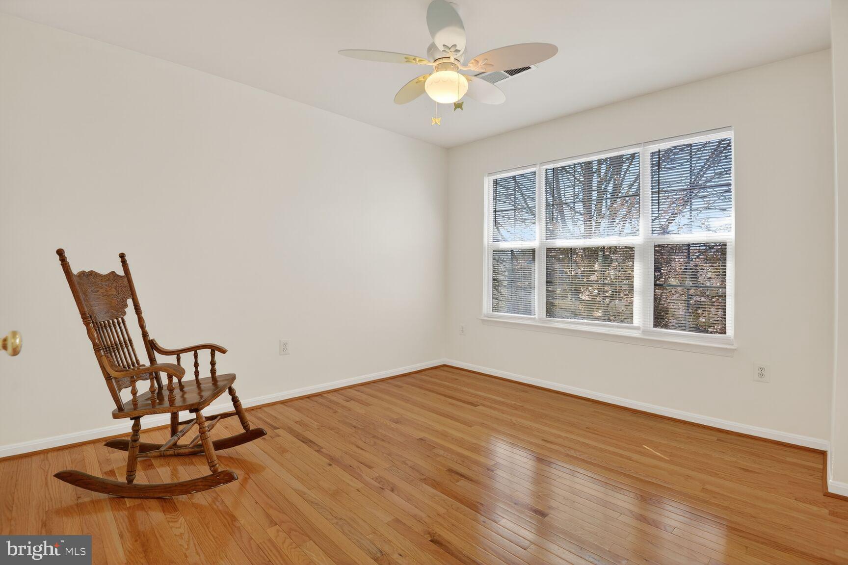 14272 Town Commons Way Gainesville, VA 20155 - Photo 21 of 32 a view of an empty room with wooden floor and a window