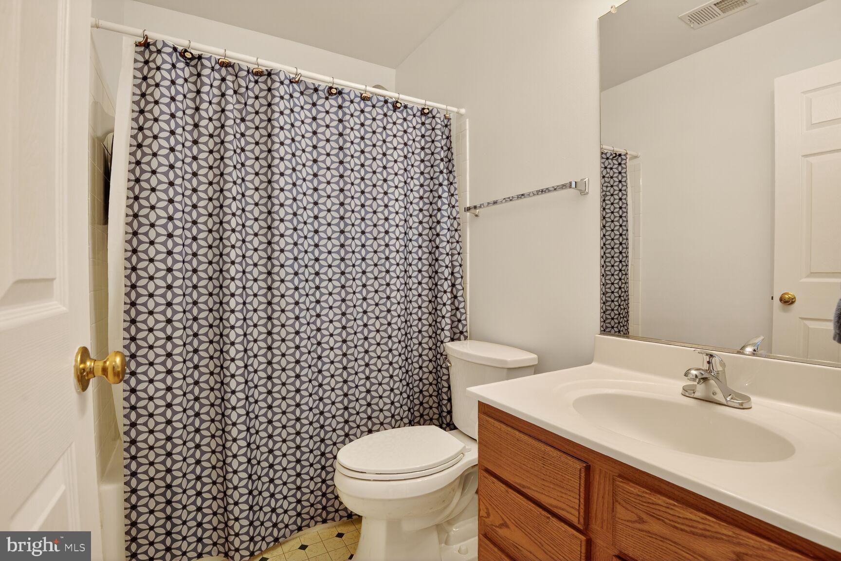 14272 Town Commons Way Gainesville, VA 20155 - Photo 23 of 32 a bathroom with a sink toilet and shower