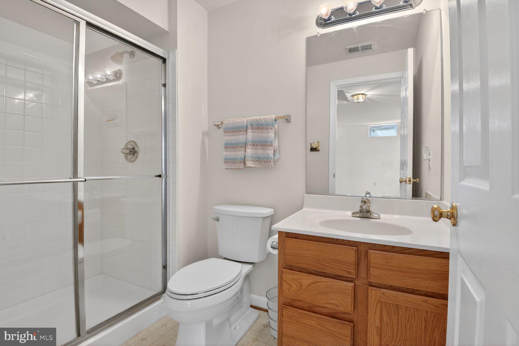 14272 Town Commons Way Gainesville, VA 20155 - Photo 27 of 32 a bathroom with a sink a toilet and shower
