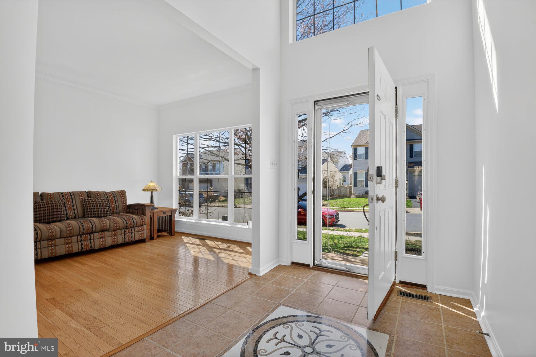 14272 Town Commons Way Gainesville, VA 20155 - Photo 4 of 32 a living room with furniture and a gate