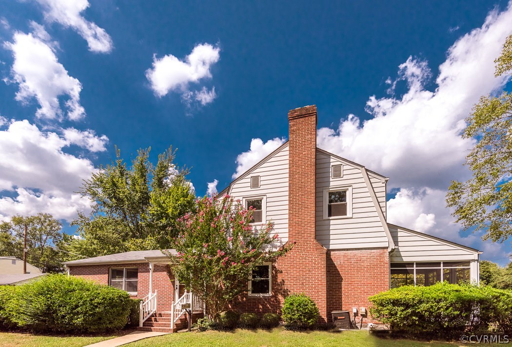 3848 Brook Road Richmond, VA 23227 - Photo 3 of 29 a front view of a house with a yard and potted plants