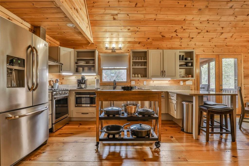 178 Novena Court Ellijay, GA 30540 - Photo 16 of 88 a kitchen with stainless steel appliances granite countertop a stove and a refrigerator