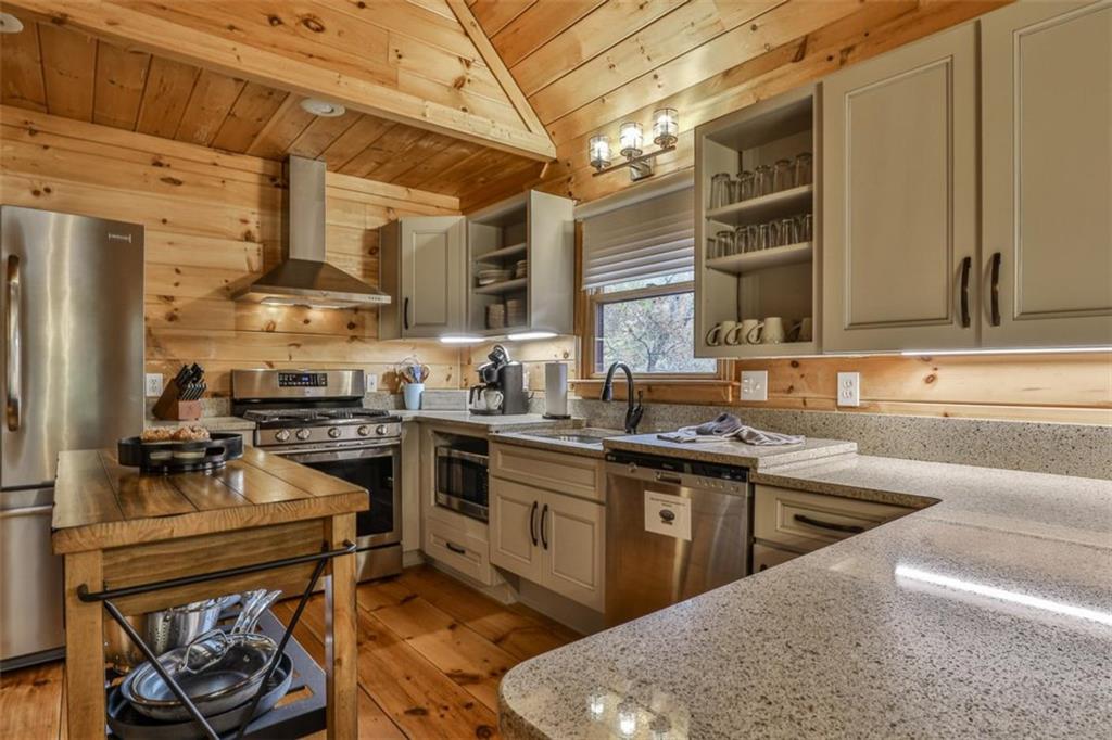 178 Novena Court Ellijay, GA 30540 - Photo 17 of 88 a kitchen with stainless steel appliances granite countertop a stove a sink and a refrigerator