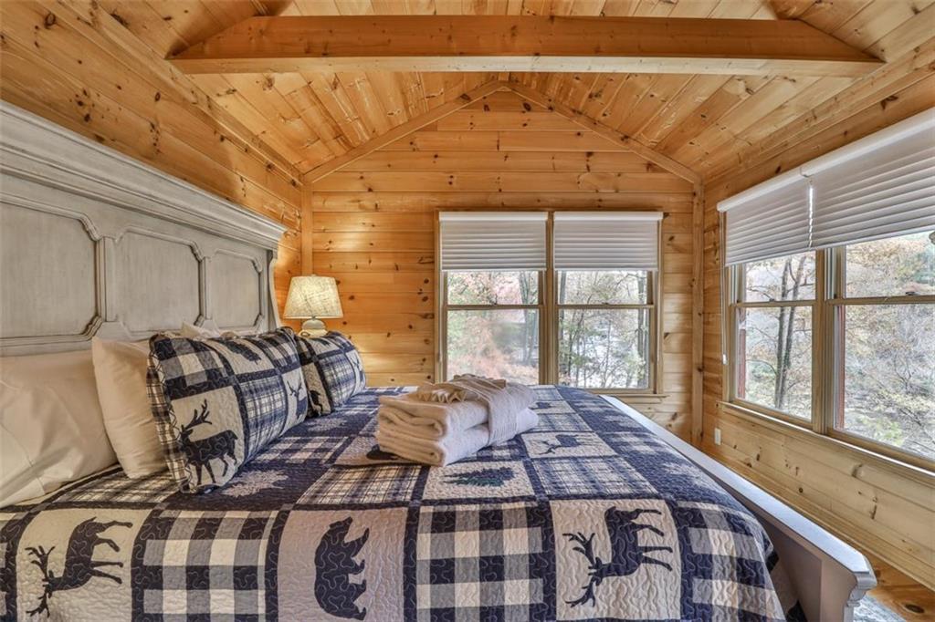 178 Novena Court Ellijay, GA 30540 - Photo 24 of 88 a bedroom with a bed next to a large window