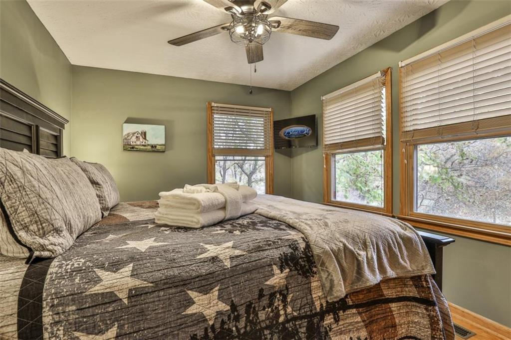 178 Novena Court Ellijay, GA 30540 - Photo 31 of 88 a bedroom with a large bed and a chandelier
