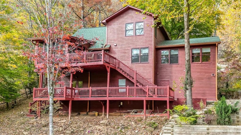178 Novena Court Ellijay, GA 30540 - Photo 67 of 88 a front view of a house with a small deck and a large tree
