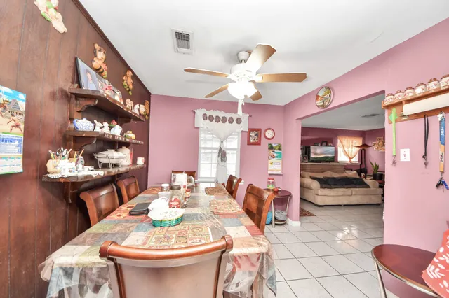 a dining room with furniture and wooden floor