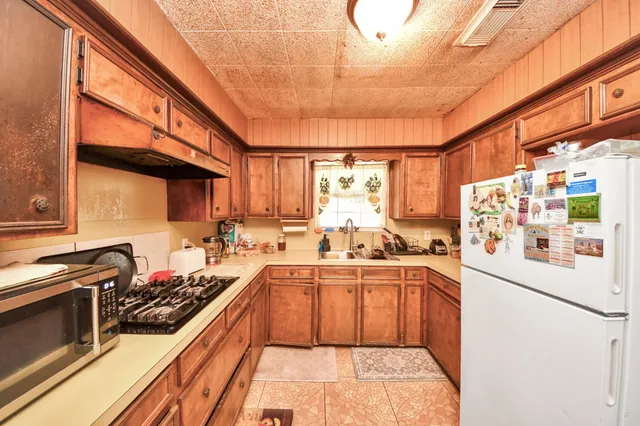 a kitchen with lots of counter top space and a sink