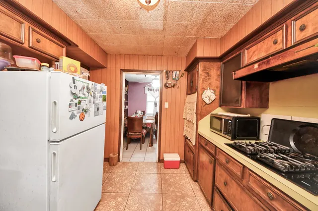 a kitchen with stainless steel appliances granite countertop a refrigerator and a stove