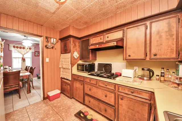 a kitchen with stainless steel appliances a sink stove and cabinets