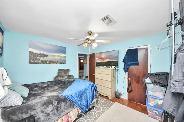 a bedroom with a large bed and a chandelier