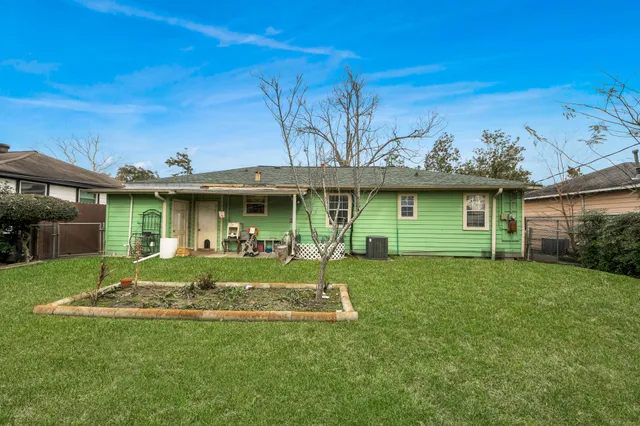 a view of a house with a yard and sitting area