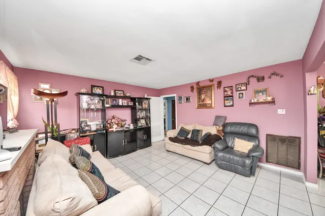 a bedroom with a bed and view of living room