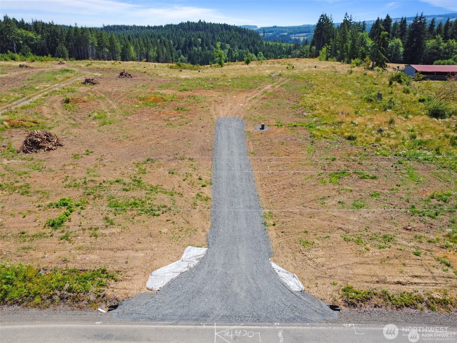 607 Brown Chehalis, WA 98532 - Photo 16 of 31 a view of a lake with beach and mountain in the back