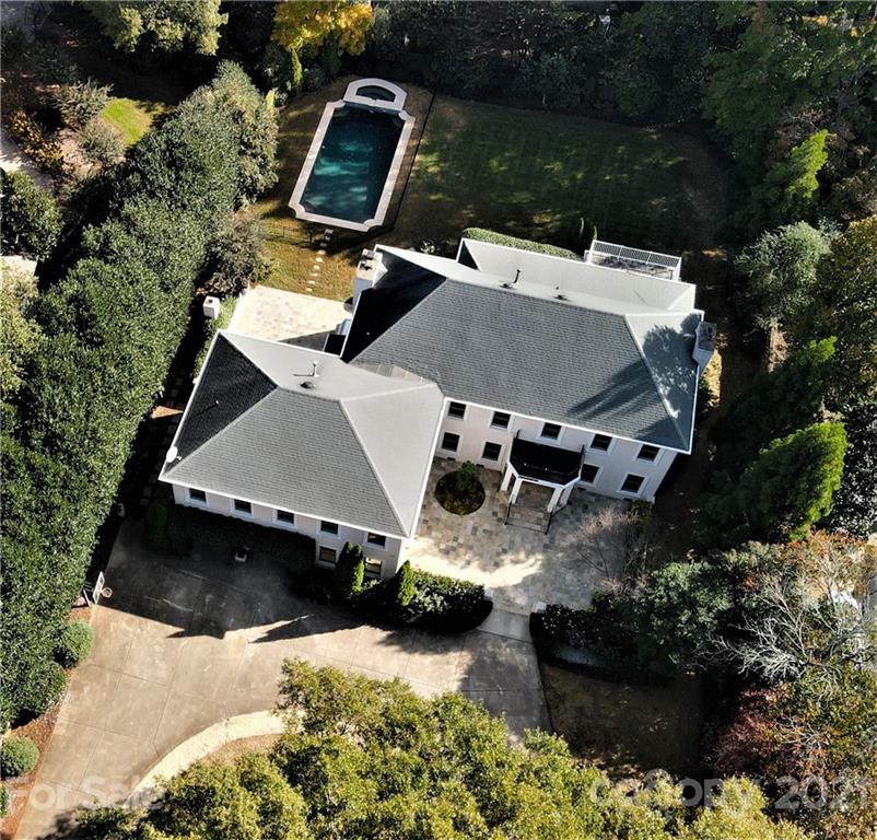 an aerial view of a house with a yard and lake view