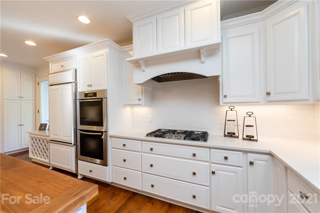 4407 Oglukian Road Charlotte, NC 28226 - Photo 13 of 48 a kitchen with stainless steel appliances white cabinets and a stove
