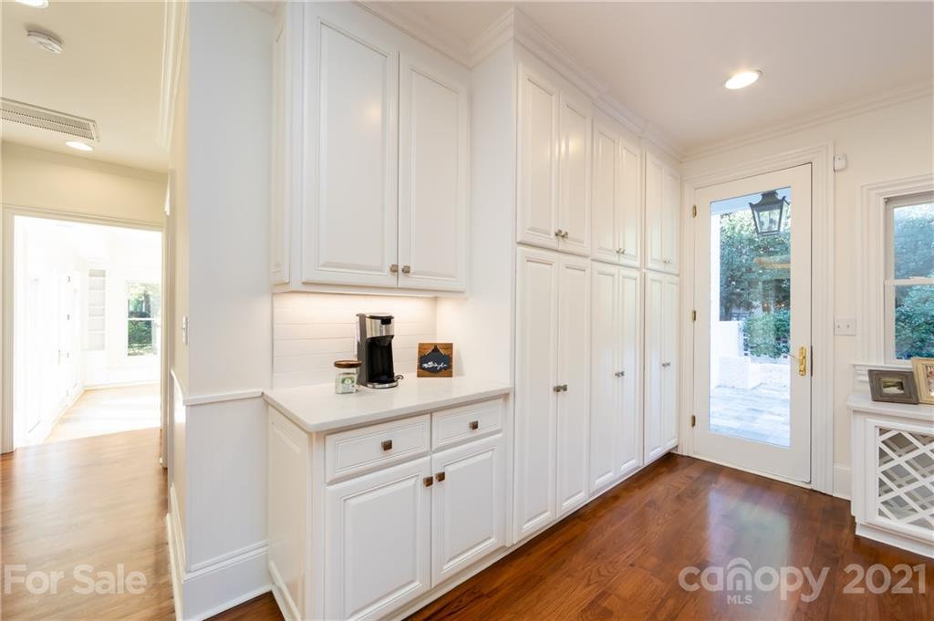 4407 Oglukian Road Charlotte, NC 28226 - Photo 15 of 48 a kitchen with granite countertop white cabinets and white appliances