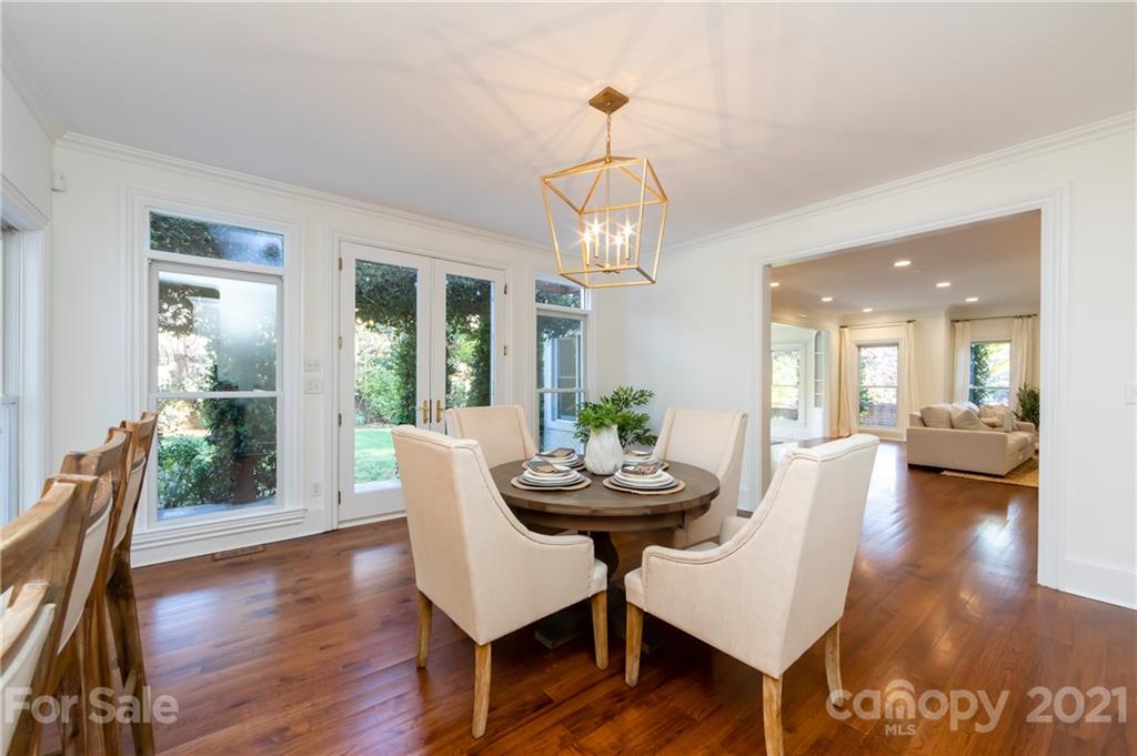 4407 Oglukian Road Charlotte, NC 28226 - Photo 17 of 48 a view of a dining room with furniture wooden floor and chandelier