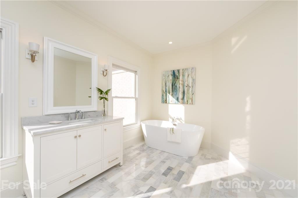 4407 Oglukian Road Charlotte, NC 28226 - Photo 33 of 48 a spacious bathroom with a double vanity sink a mirror and a bathtub