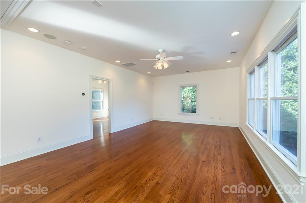 4407 Oglukian Road Charlotte, NC 28226 - Photo 36 of 48 an empty room with wooden floor and windows