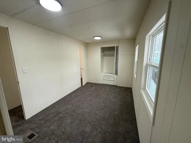 a view of a hallway to rooms