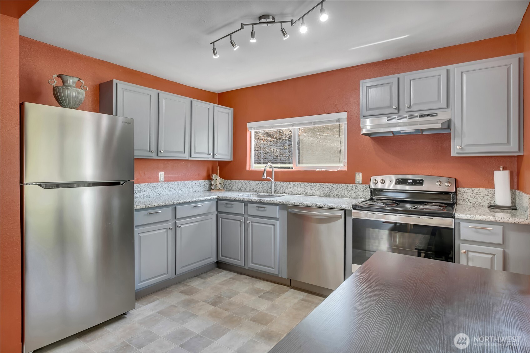 2307 Southwest Myrtle Street Seattle, WA 98106 - Photo 9 of 30 a kitchen with stainless steel appliances granite countertop a refrigerator a sink dishwasher a stove top oven a refrigerator and cabinets