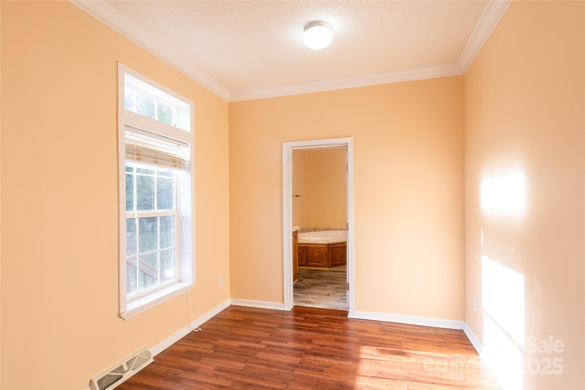407 Monteith Gap Road Cullowhee, NC 28723 - Photo 15 of 23 a view of an empty room with wooden floor with windows