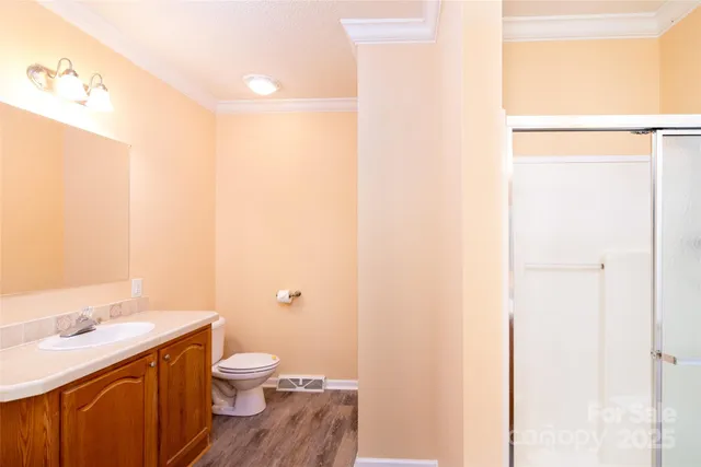 a bathroom with a granite countertop sink toilet and a mirror