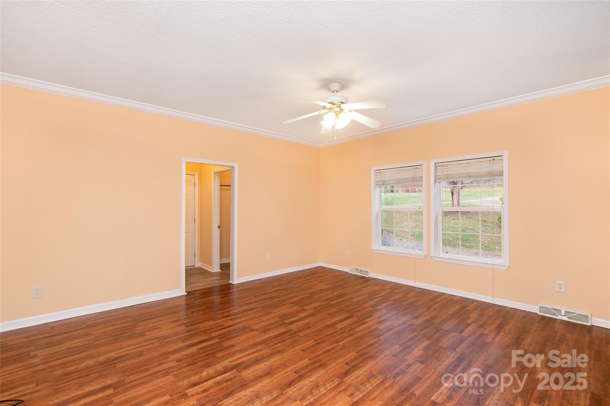 407 Monteith Gap Road Cullowhee, NC 28723 - Photo 23 of 23 an empty room with wooden floor and window