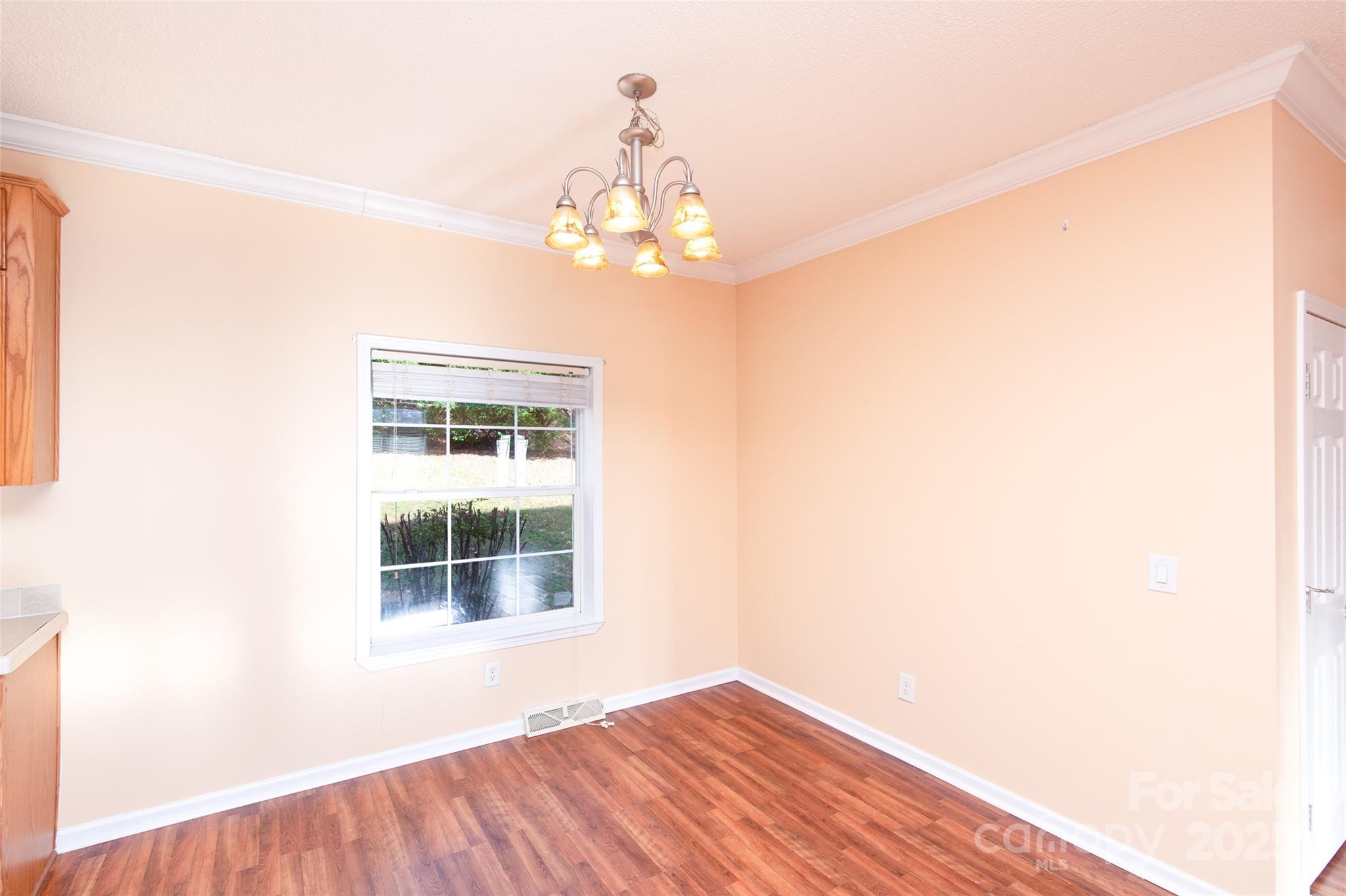 407 Monteith Gap Road Cullowhee, NC 28723 - Photo 6 of 23 a view of a big room with wooden floor and chandelier