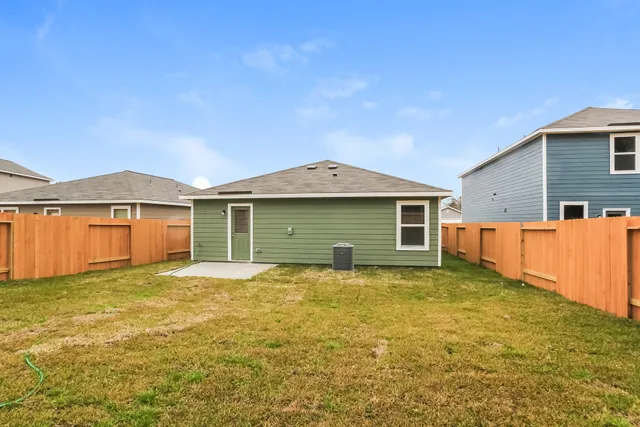 a front view of a house with yard and garage
