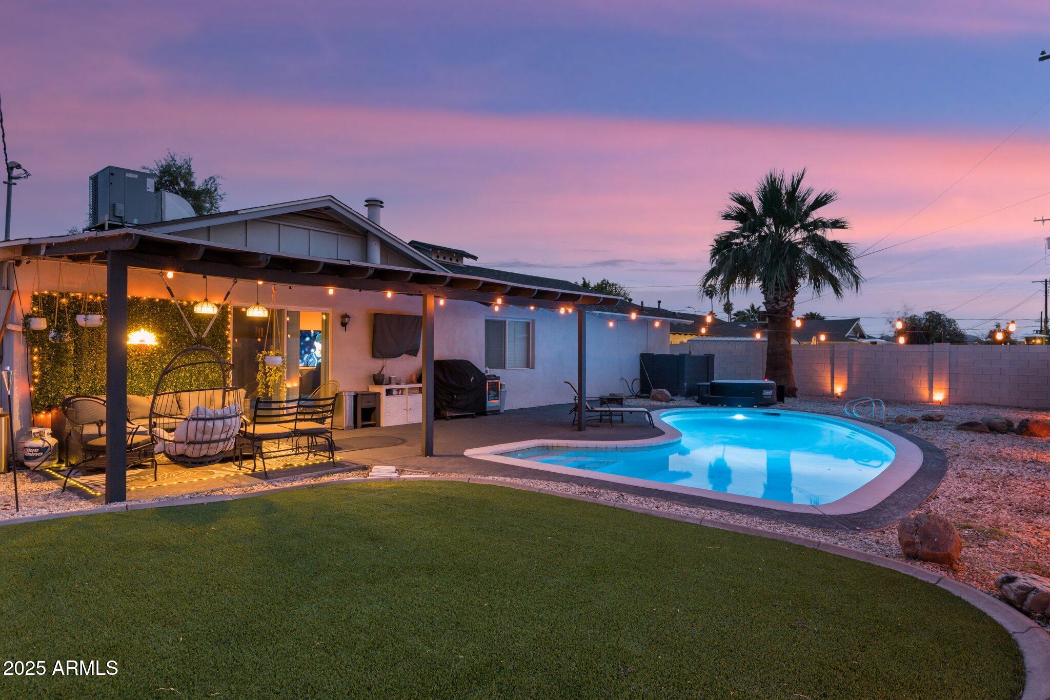 a view of a house with swimming pool and sitting area