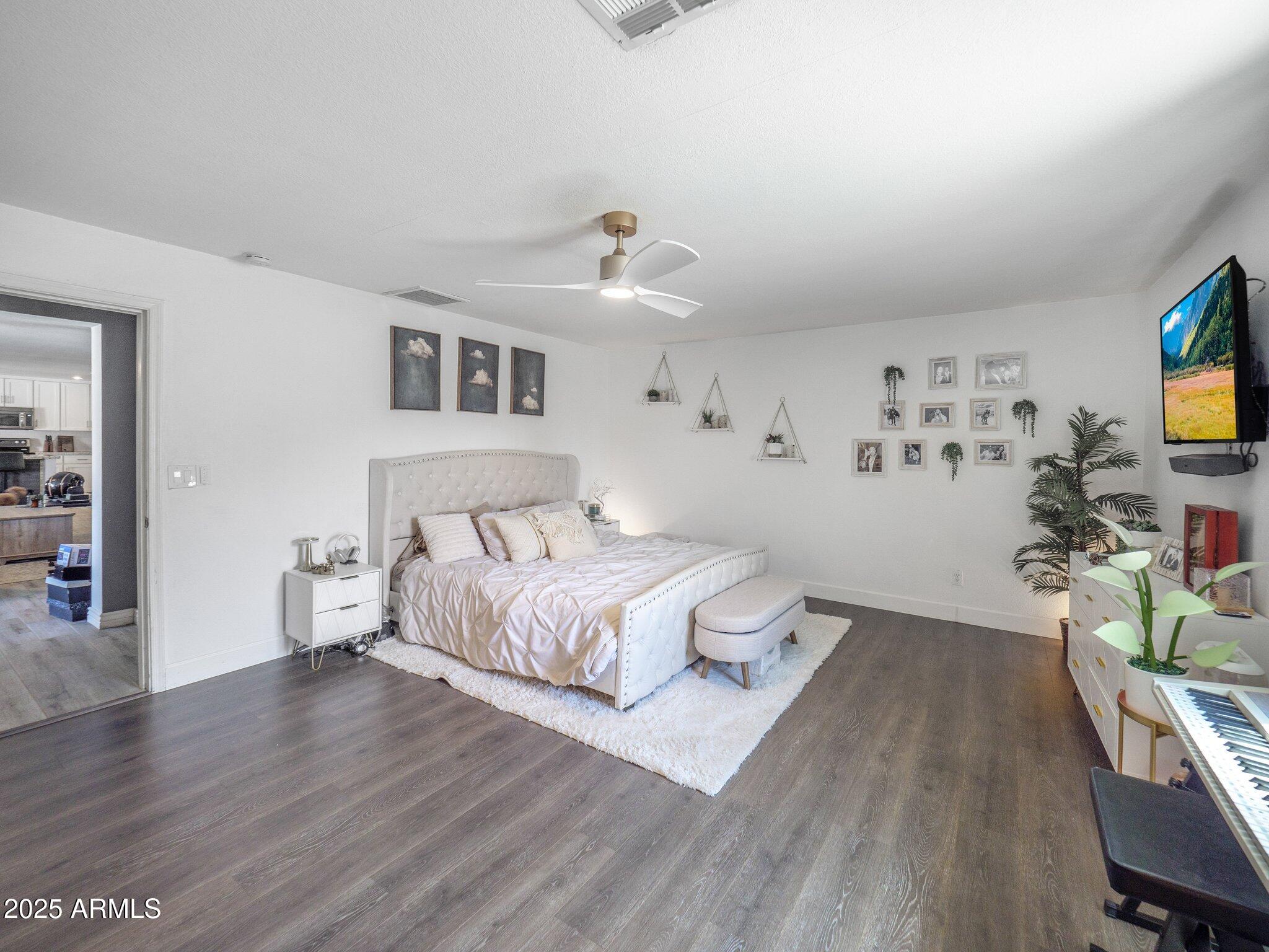 8728 East Monte Vista Road Scottsdale, AZ 85257 - Photo 11 of 28 a spacious bedroom with a bed and a flat screen tv