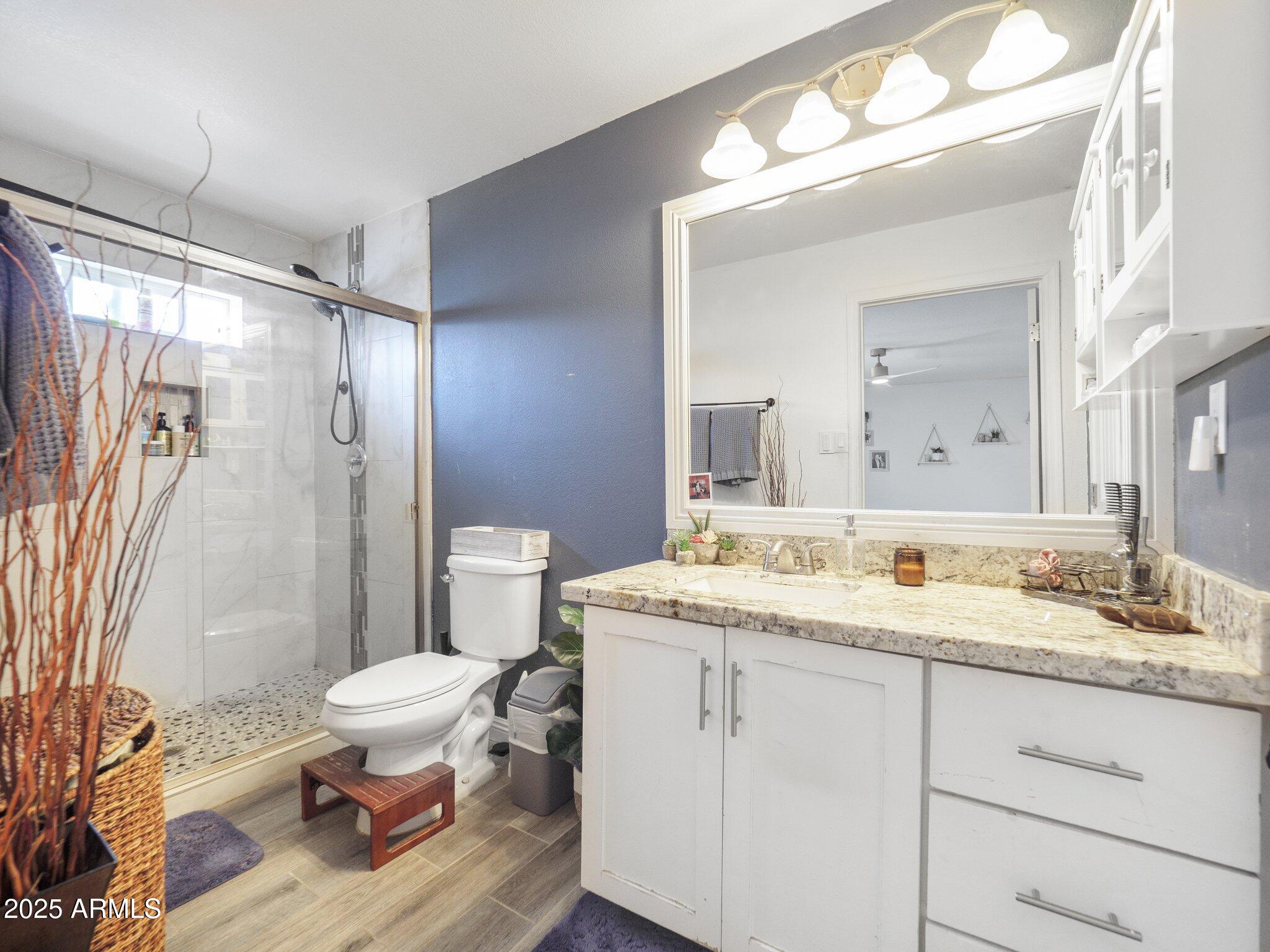 8728 East Monte Vista Road Scottsdale, AZ 85257 - Photo 13 of 28 a spacious bathroom with a granite countertop sink toilet mirror and a shower