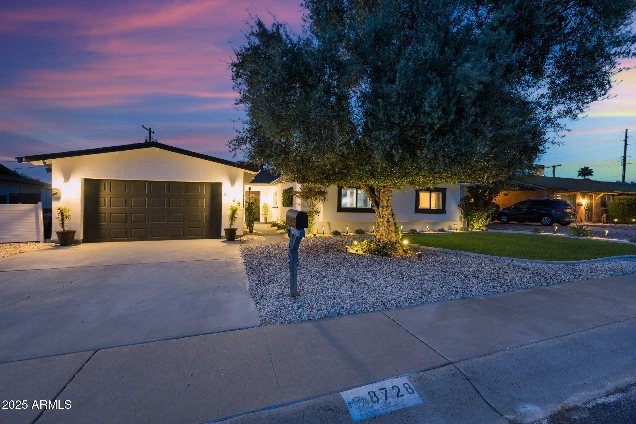 8728 East Monte Vista Road Scottsdale, AZ 85257 - Photo 2 of 28 a front view of a house with garden