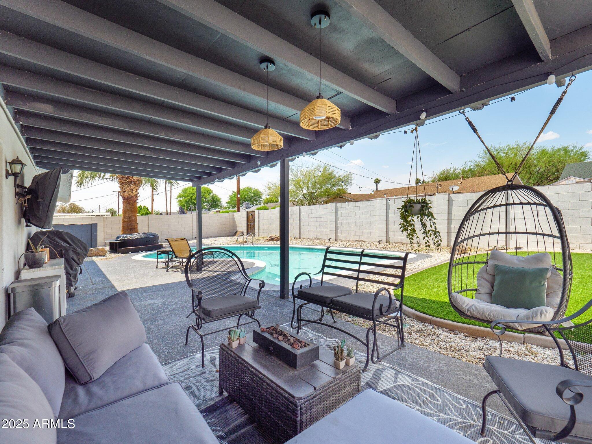 8728 East Monte Vista Road Scottsdale, AZ 85257 - Photo 26 of 28 a living room with furniture a table and a large window