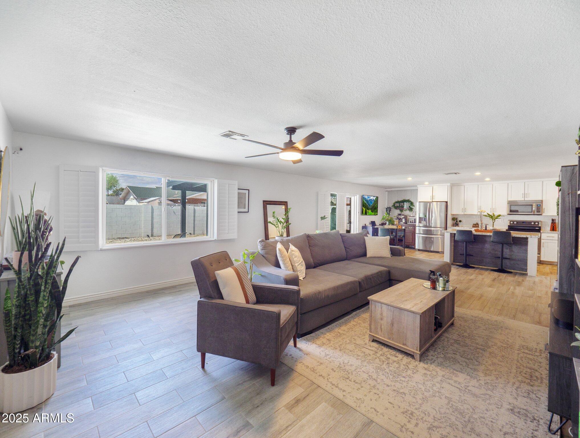 8728 East Monte Vista Road Scottsdale, AZ 85257 - Photo 3 of 28 a living room with furniture and a potted plant