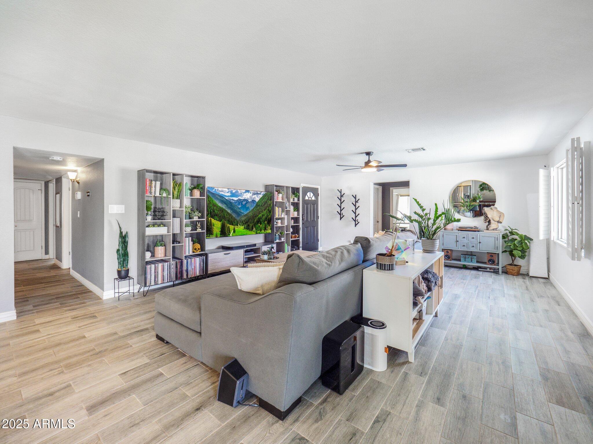 8728 East Monte Vista Road Scottsdale, AZ 85257 - Photo 4 of 28 a living room with furniture and a wooden floor