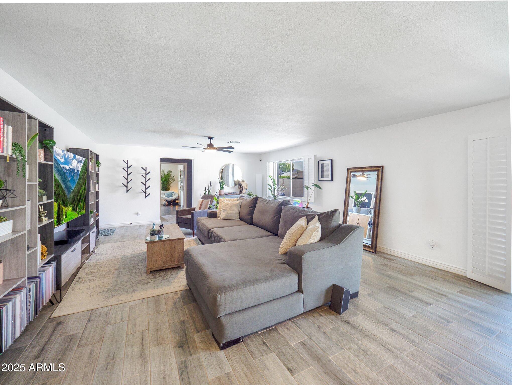 8728 East Monte Vista Road Scottsdale, AZ 85257 - Photo 5 of 28 a living room with furniture and a flat screen tv